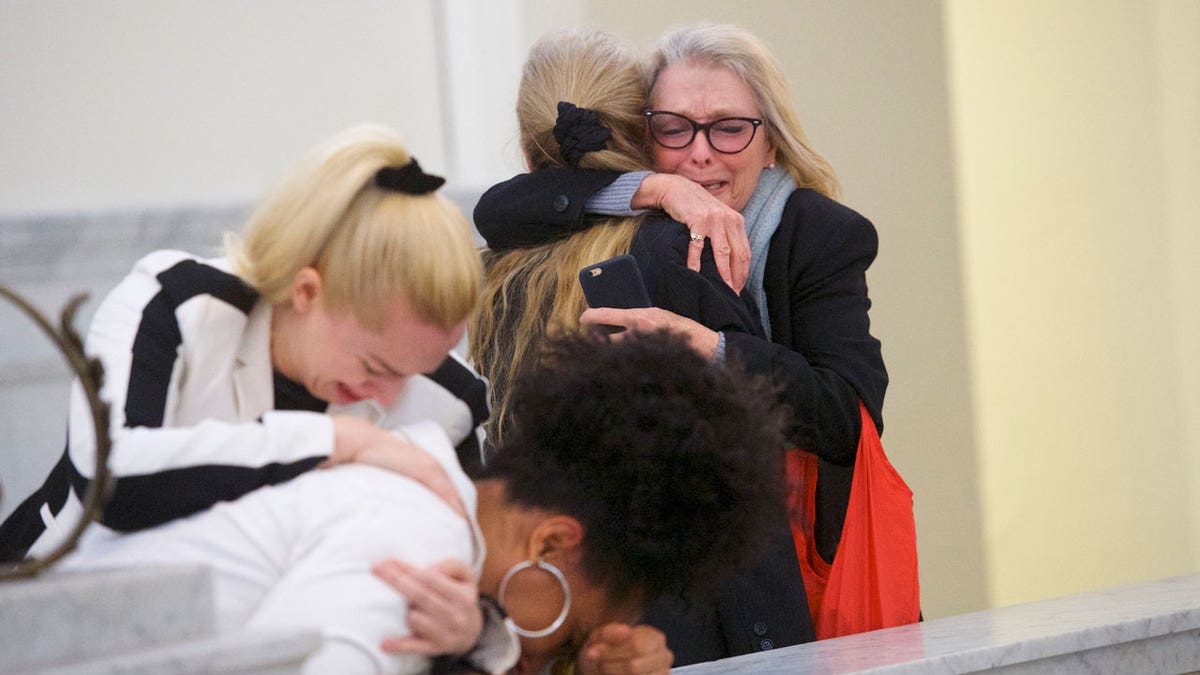 Victoria Valentino crying and hugging someone at Bill Cosby's trial