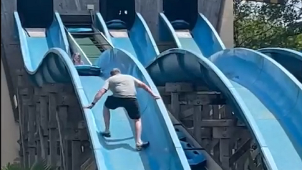 Father climbs water slide to get to daughter who is stuck