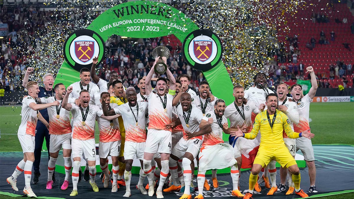 West Ham players celebrate with trophy
