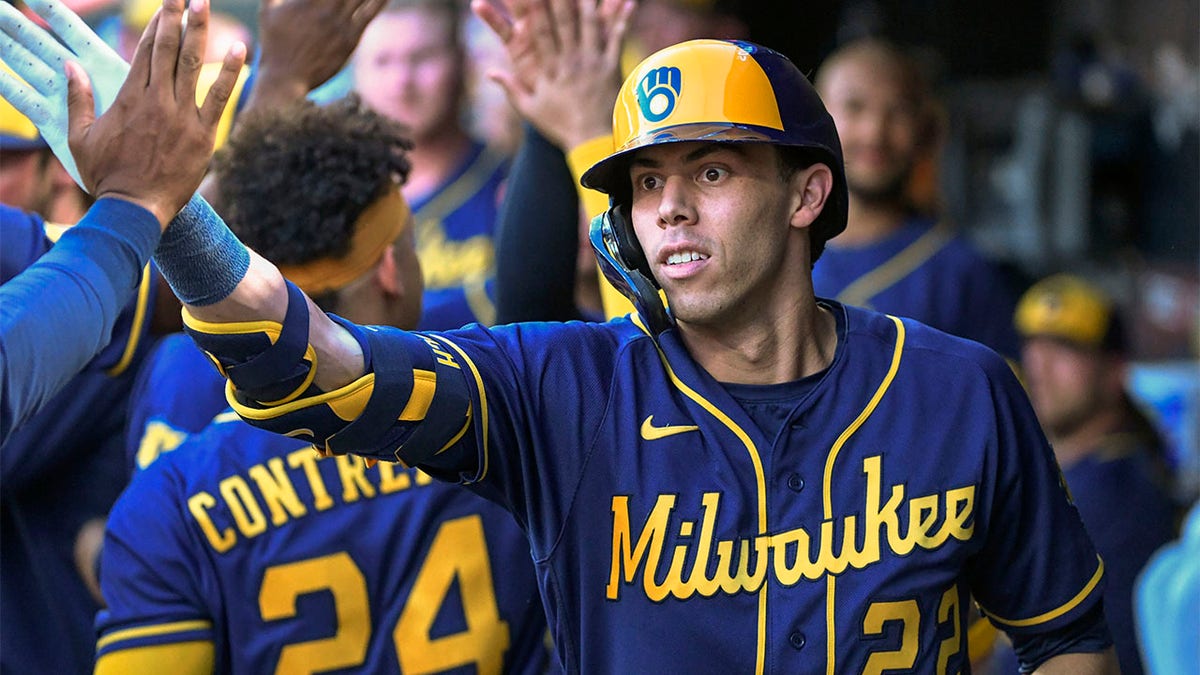 Christian Yelich high-fives teammates