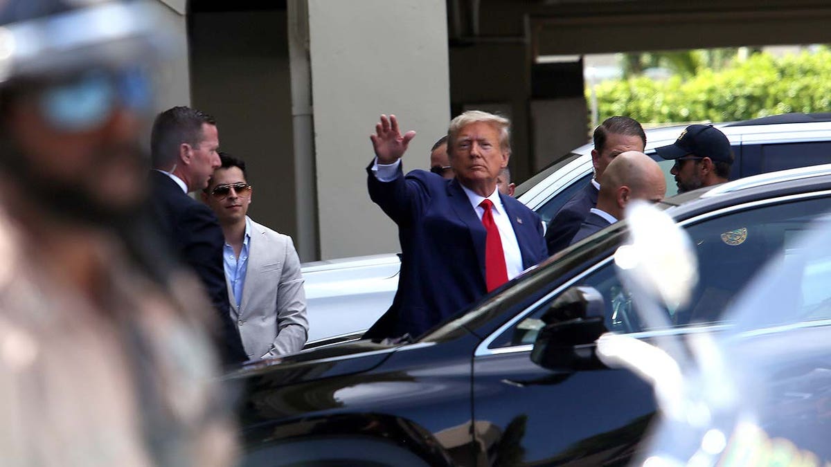 Former U.S. President Donald Trump waves as he makes a visit to the Cuban restaurant Versailles