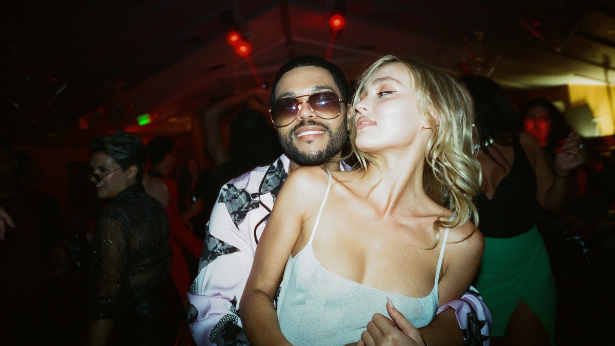Abel "The Weeknd" Tesfaye and Lily-Rose Depp hugging in a scene from The Idol