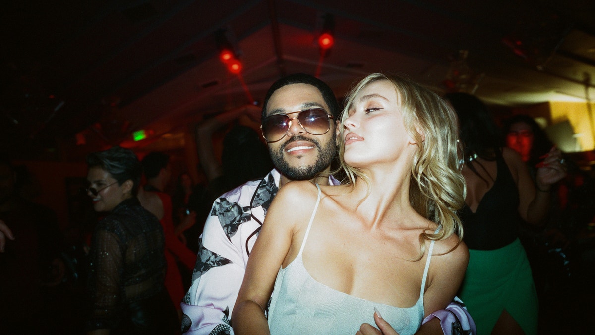 Abel "The Weeknd" Tesfaye and Lily-Rose Depp hugging in a scene from The Idol