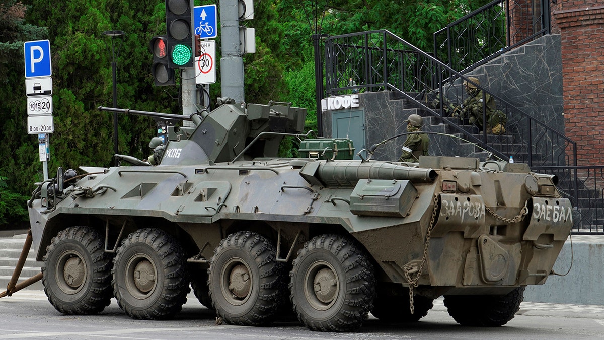 An armoured personnel carrier parked in Rostov as Wagner group mercenaries patrol the area