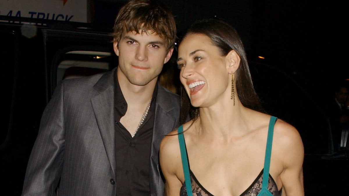 Demi Moore shows some skin wearing a sheer green dress with black lace bra for date with Ashton Kutcher