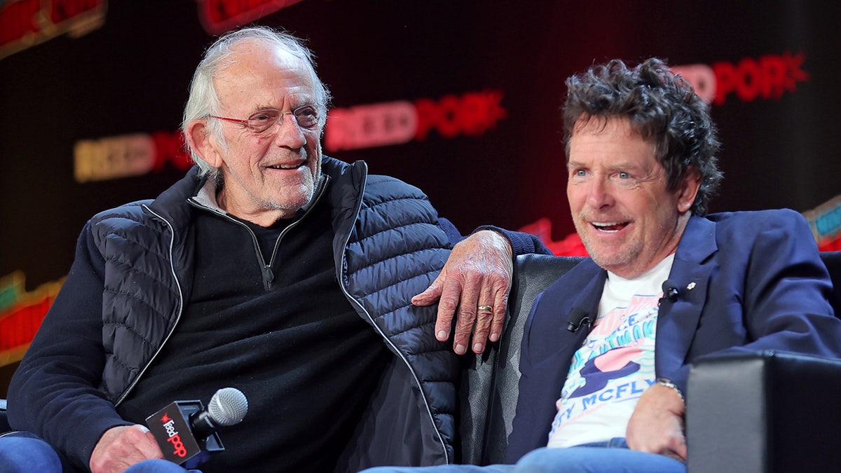 Michael J. Fox and Christopher Lloyd laugh during Back to the Future reunion panel