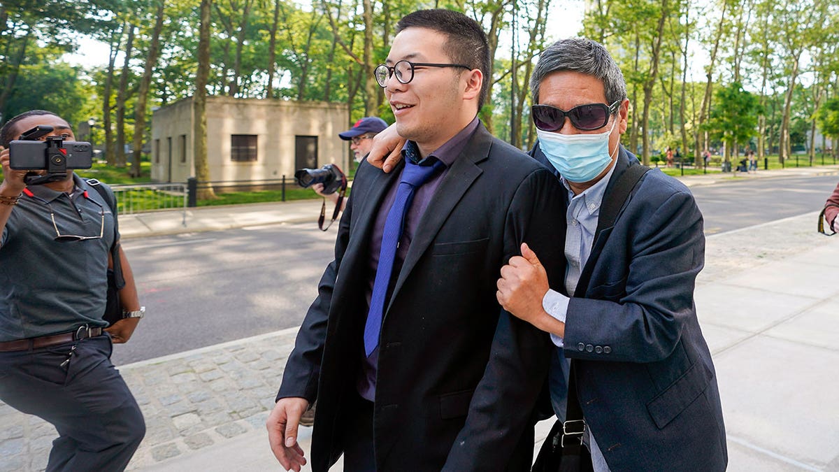 Zhu Yong outside as he walks into court