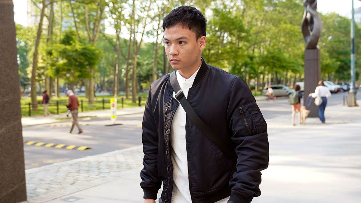 Zheng Congying outside as he leaves a courthouse