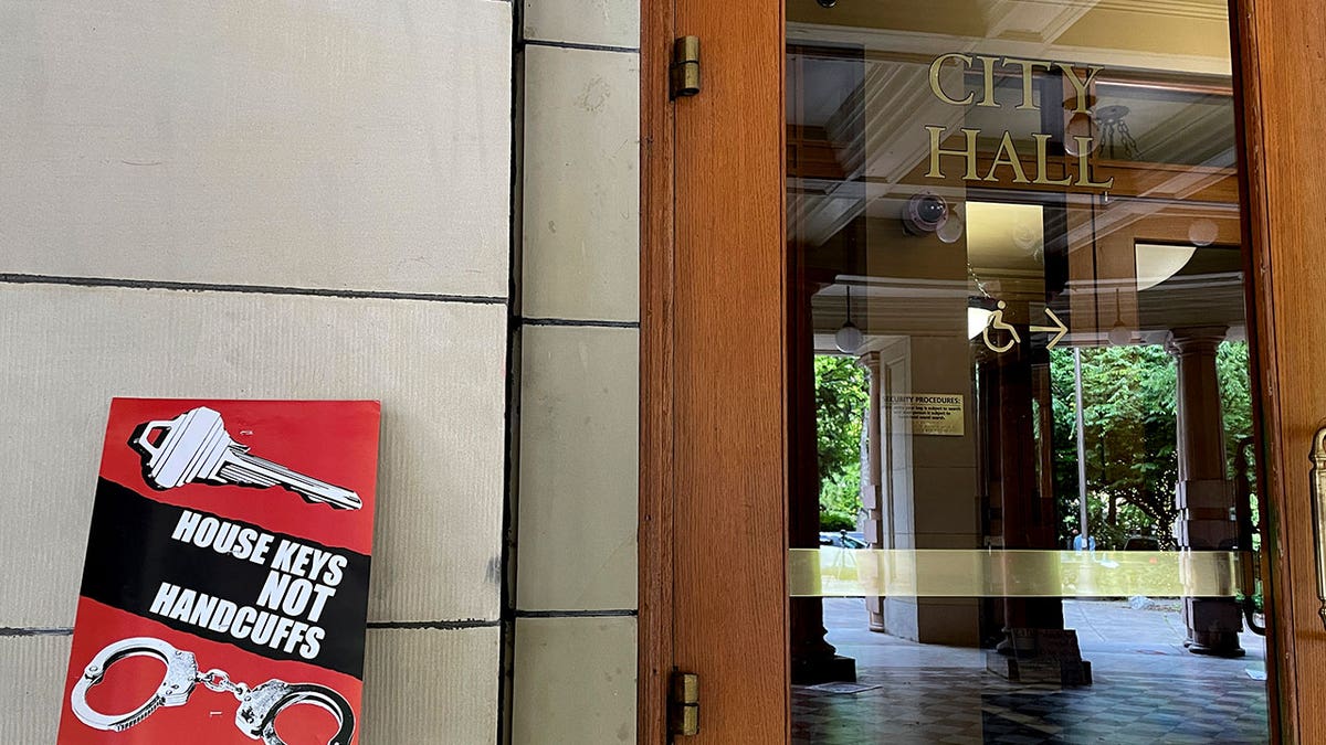 Protest sign next to Portland City Hall door