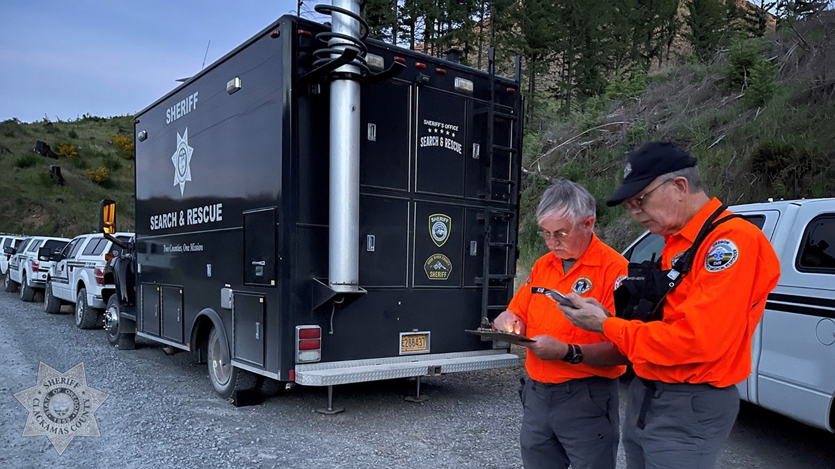 search team members along road