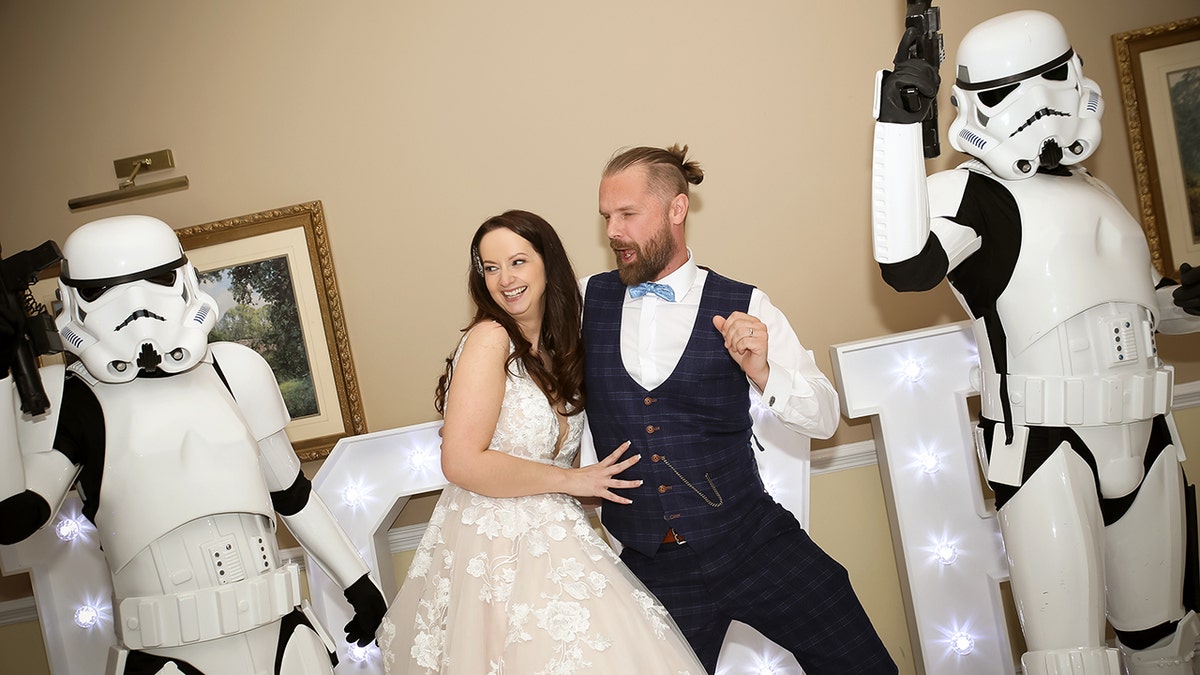 Bride and groom dance with storm troopers