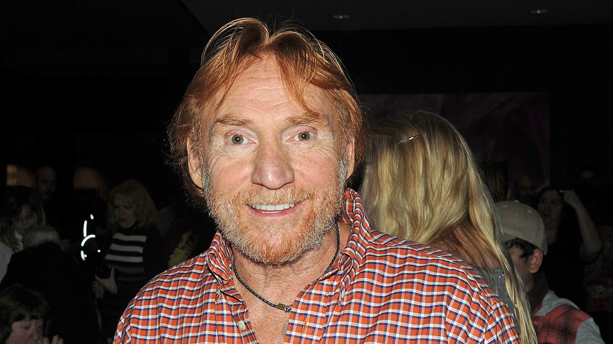 Danny Bonaduce wears plaid shirt with a necklace at event