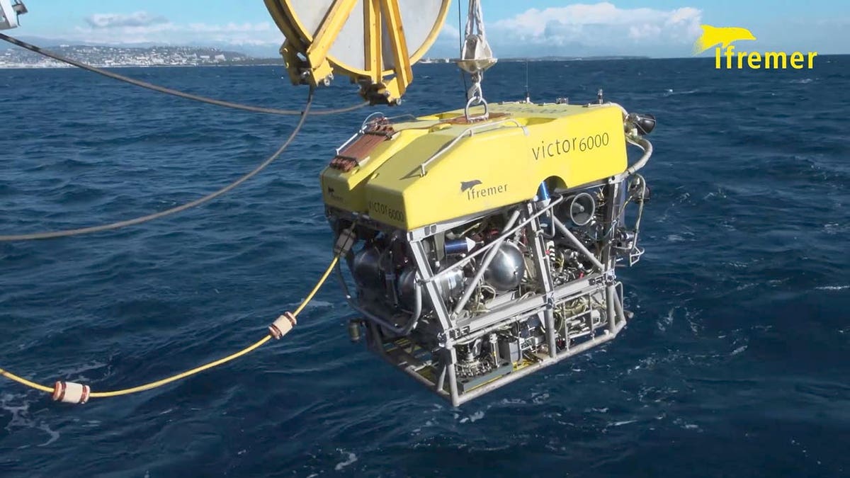 Victor 6000 - an unmanned French robot which can dive up to 6,000 metres hangs from crane arm above Atlantic Ocean
