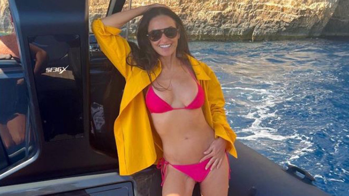 Demi Moore in a pink bikini on a boat