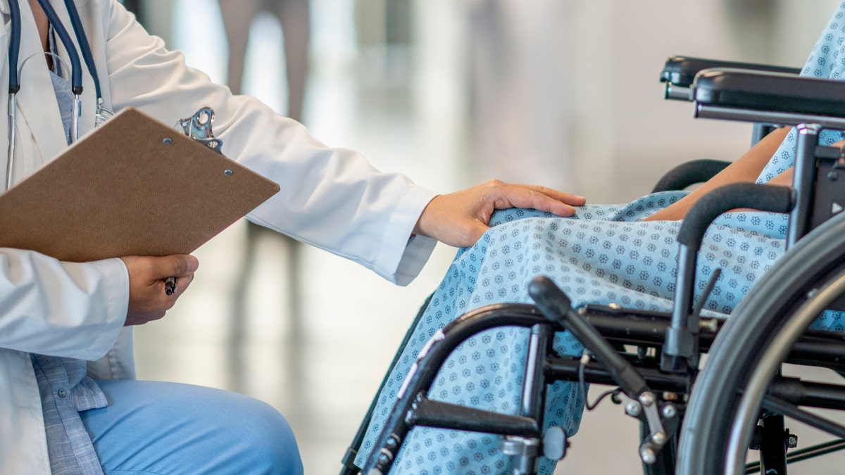 Doctor with patient in wheelchair