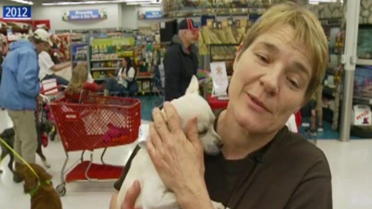 Barbara Wible holding a dog in 2012