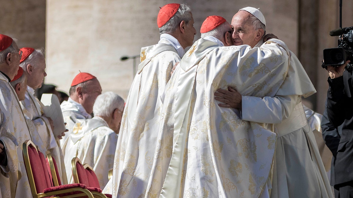 Pope Francis embraces cardinals