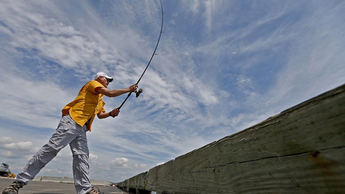 A man casting a fishing pole