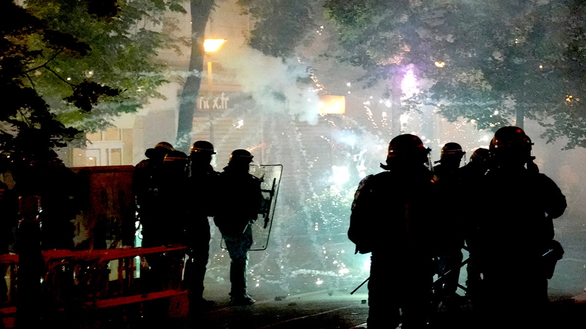 Fireworks are shot at French police during a riot in Nanterre, outside of Paris