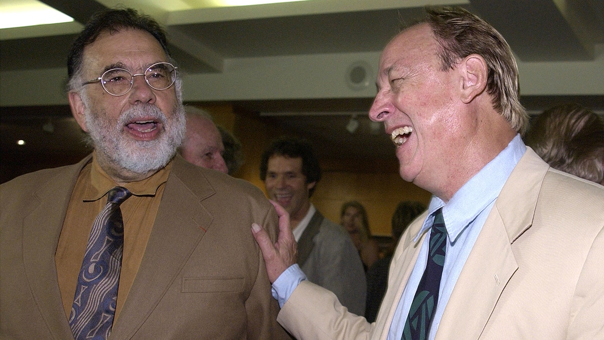 Francis Ford Coppola laughs with actor Frederic Forrest