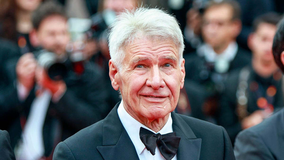 Harrison Ford wears a tux on the red carpet at Cannes Film Festival.