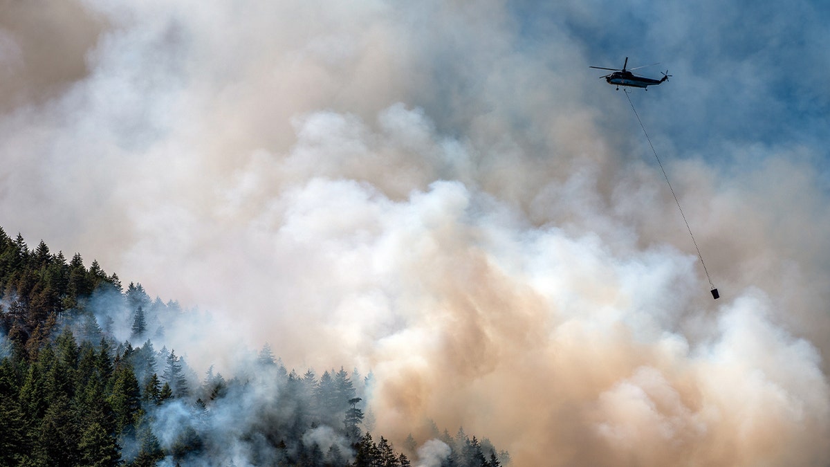 Helicopter drops water on Canadian wildfire