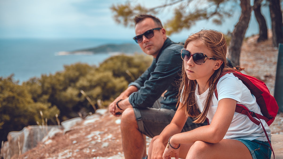 dad and daughter at odds while sitting outside