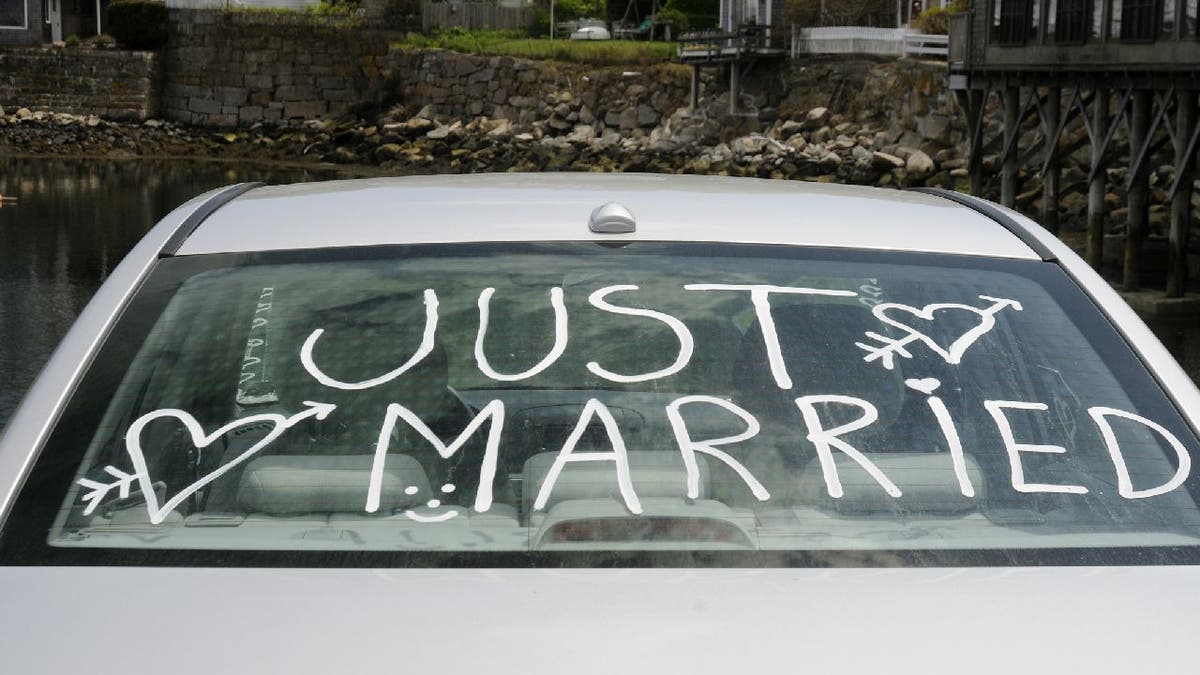Newlyweds shamed by social media users for advertising Venmo username on  car window