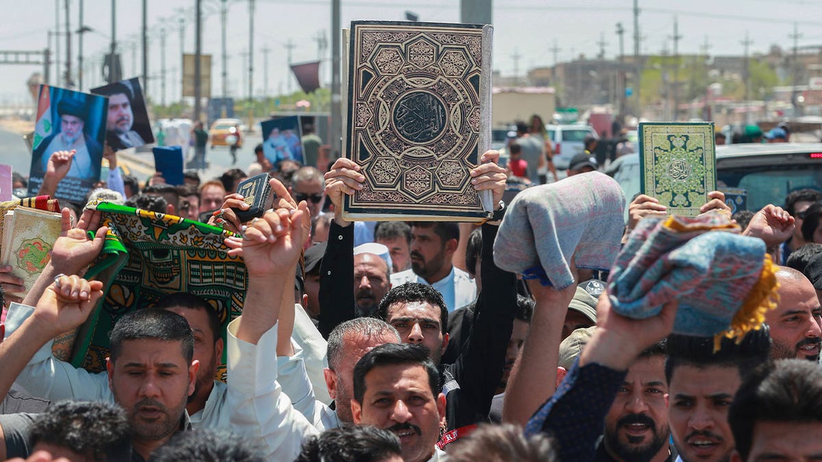 Iraqis holding the Quran 