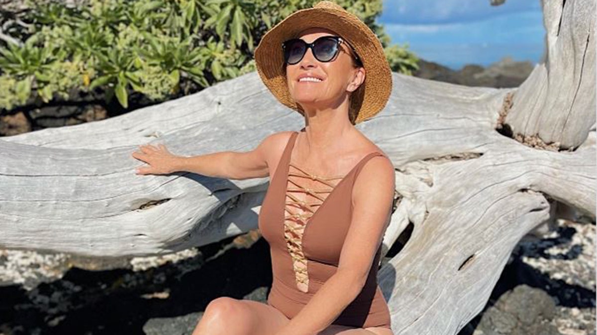Jane Seymour in a brown swimsuit at the beach