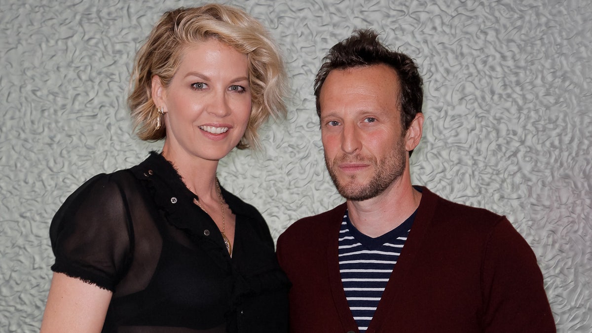 Jenna Elfman sports sheer black top next to husband and Bodhi Elfman