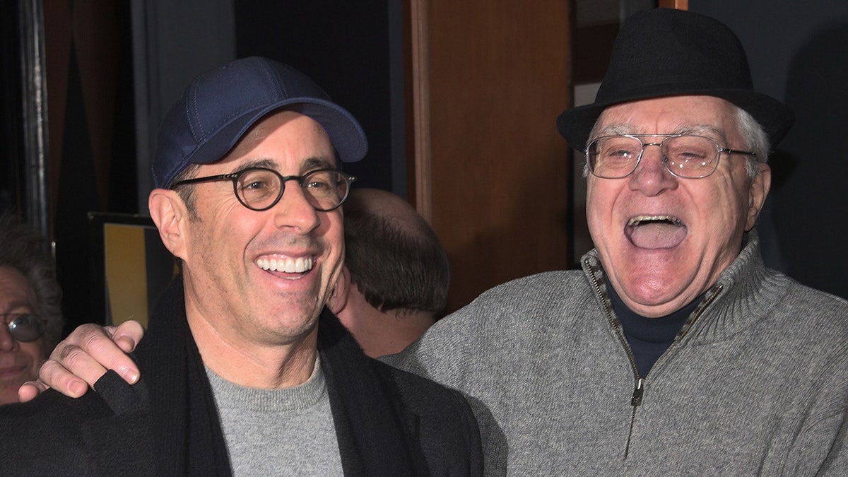 Jerry Seinfeld and Pat Cooper share a laugh outside of Caroline's comedy club