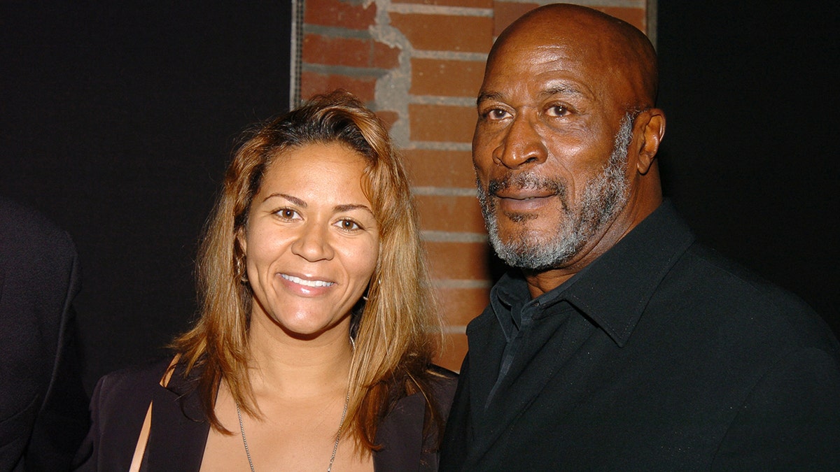 John Amos and daughter Shannon smile at Hollywood event