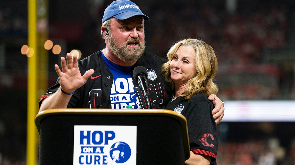 Zac Brown Band musician John Driskell Hopkins wears blue hat and t-shirt with wife