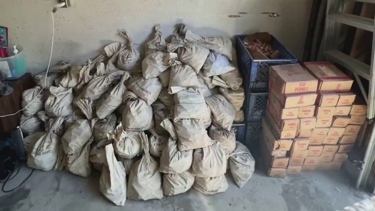 Dozens of bank bags sit next to crates of penies