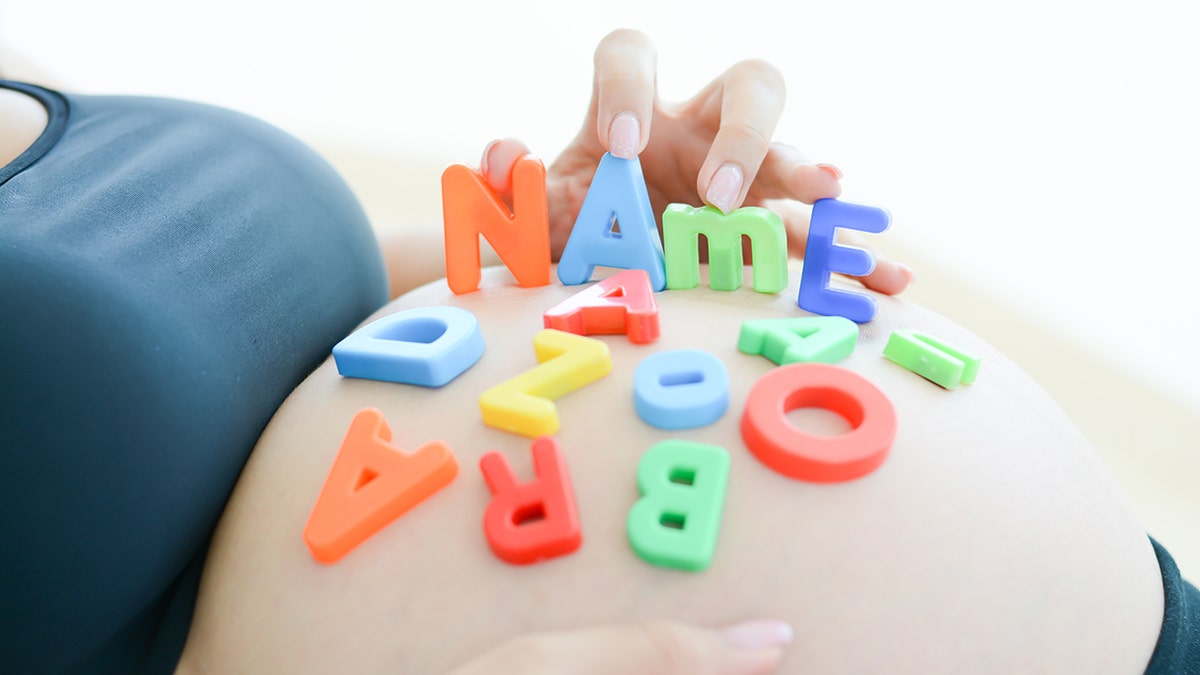 pregnant belly with letters