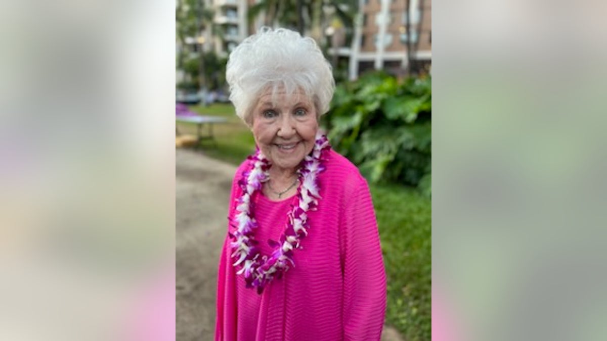 Melba standing outside wearing a lei