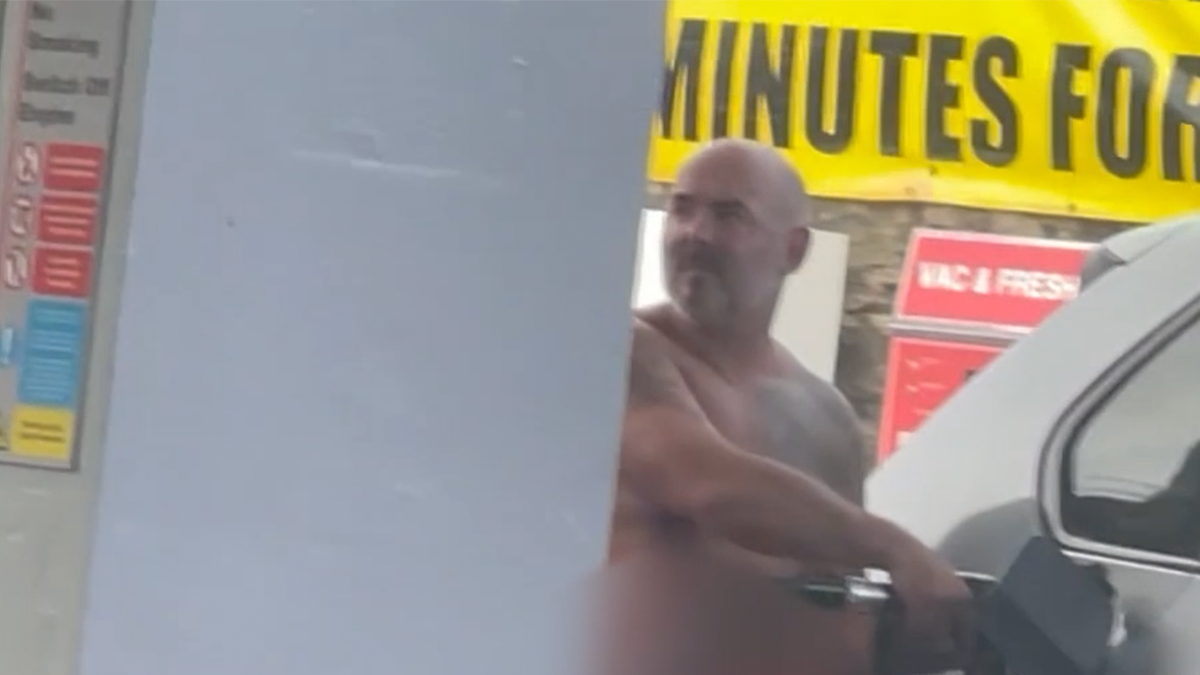 Naked man pumps gas