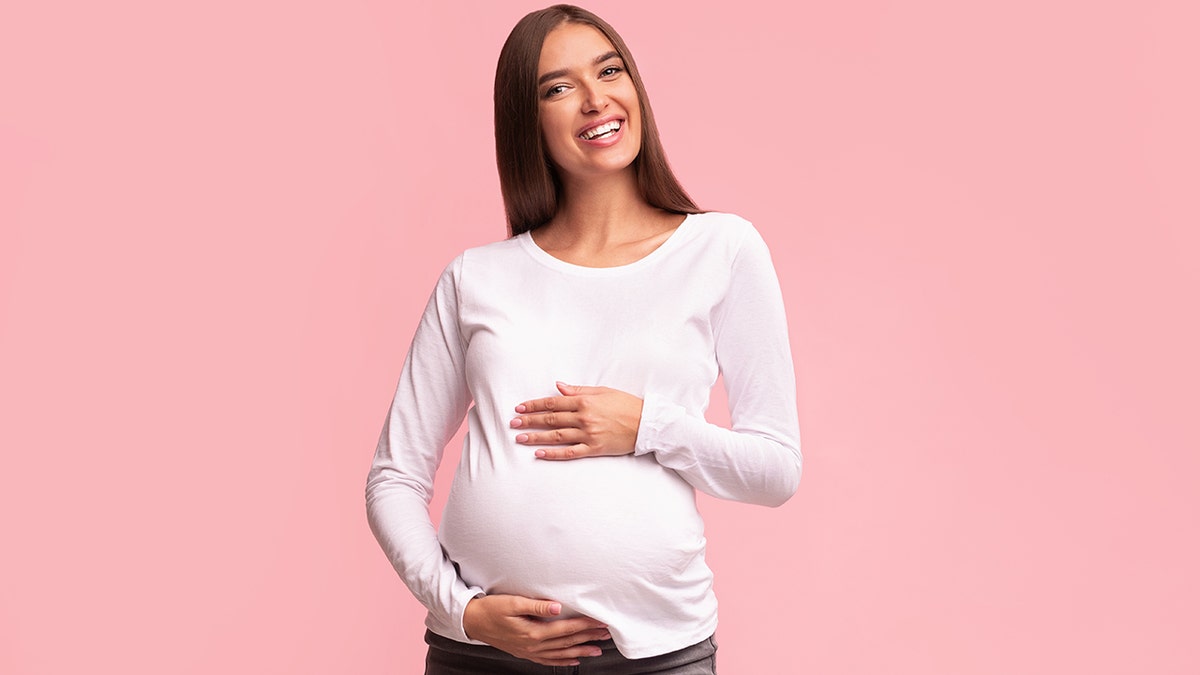 pregnant woman with pink background