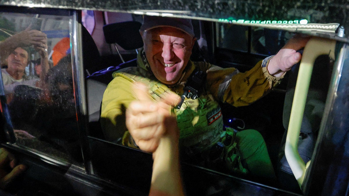 Wagner Group chief Yevgeny Prigozhin greets bystanders as he leaves Rostov following his short-lived rebellion