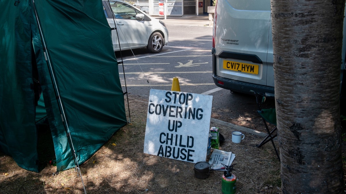 "stop covering up child abuse" sign outside Tavistock clinic