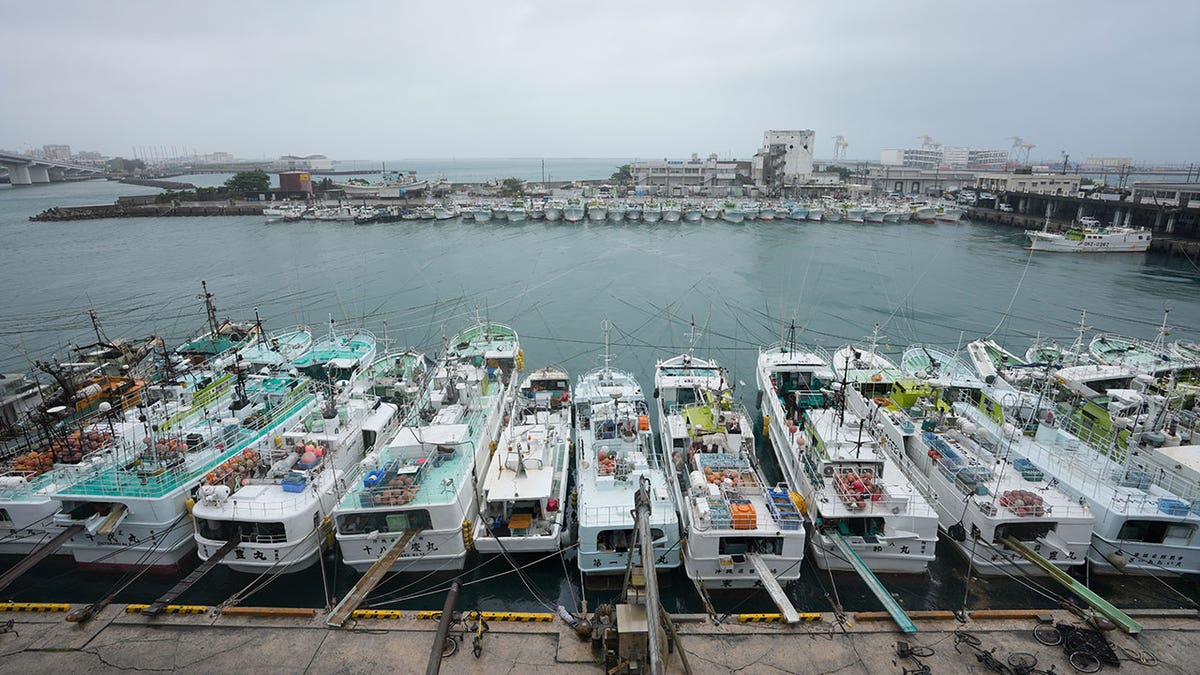 As Tropical Storm Mawar approaches, fishing boats are secured by rope at the Tomari fishery port in Naha in the main Okinawa island of southern Japan on June 1, 2023.