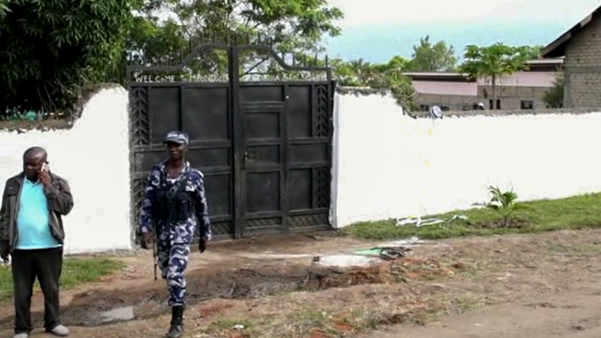 Ugandan security forces are seen outside the gate of the Lhubiriha Secondary School