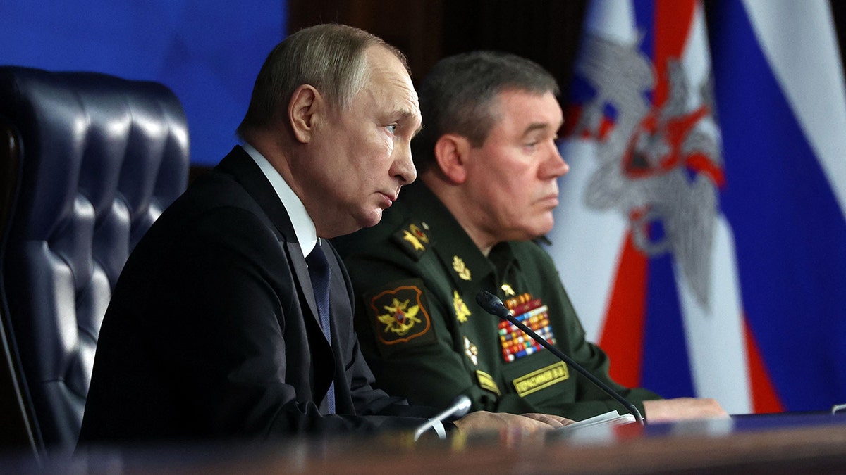 Russian President Vladimir Putin sits next to Russian General Staff Valery Gerasimov