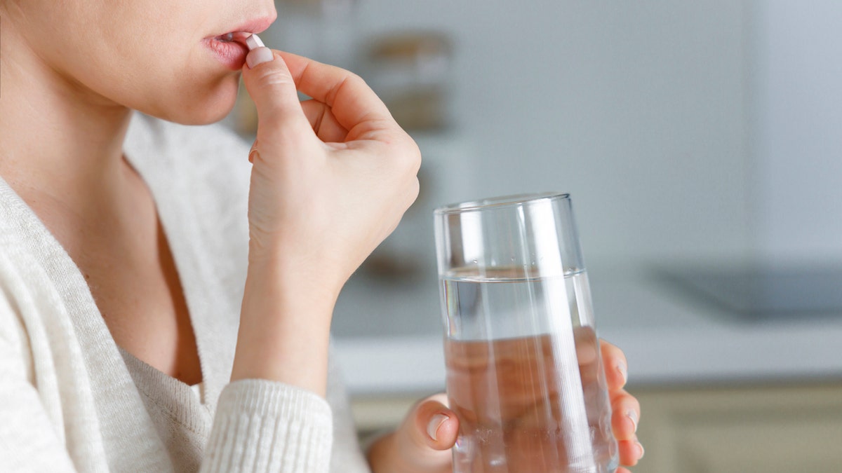 Woman taking pill