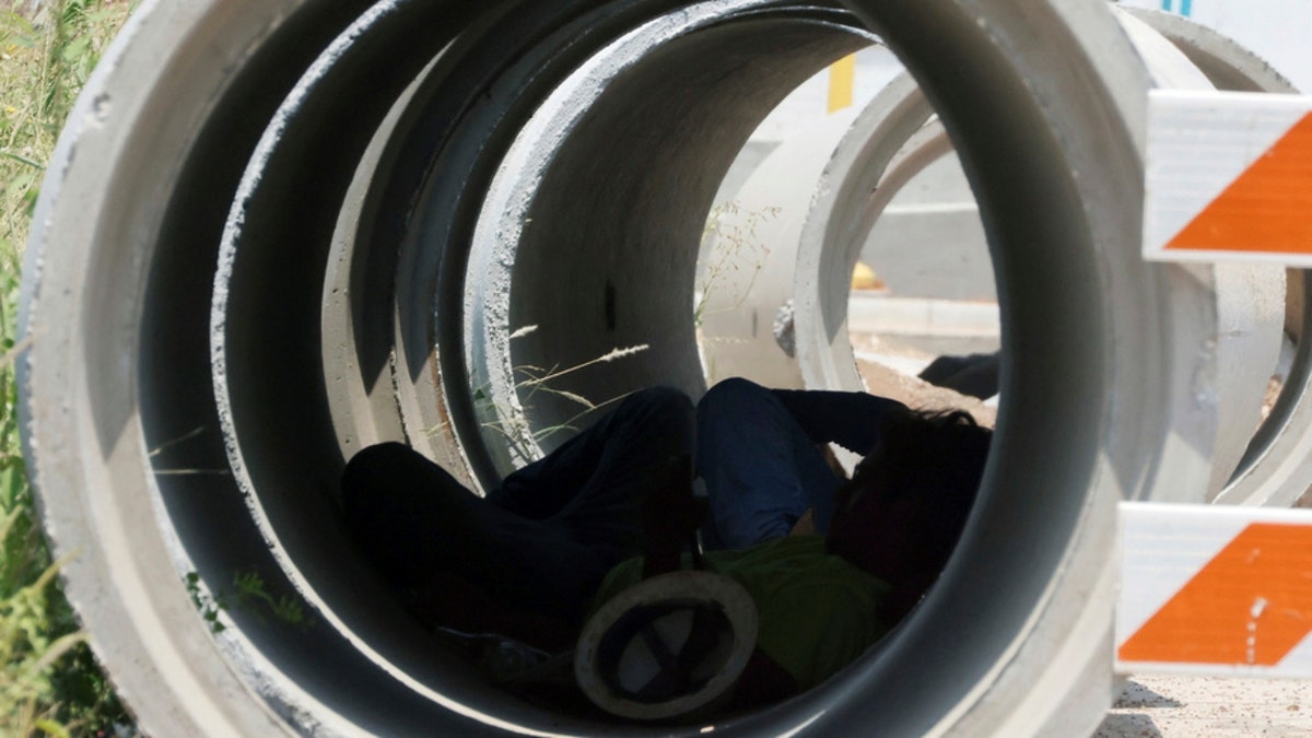 A construction worker takes a break from the sun