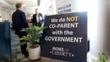 A sign reading "We Do Not CO-PARENT with the Government" is seen in the hallway during the inaugural Moms For Liberty Summit at the Tampa Marriott Water Street on July 15, 2022 in Tampa, Florida.