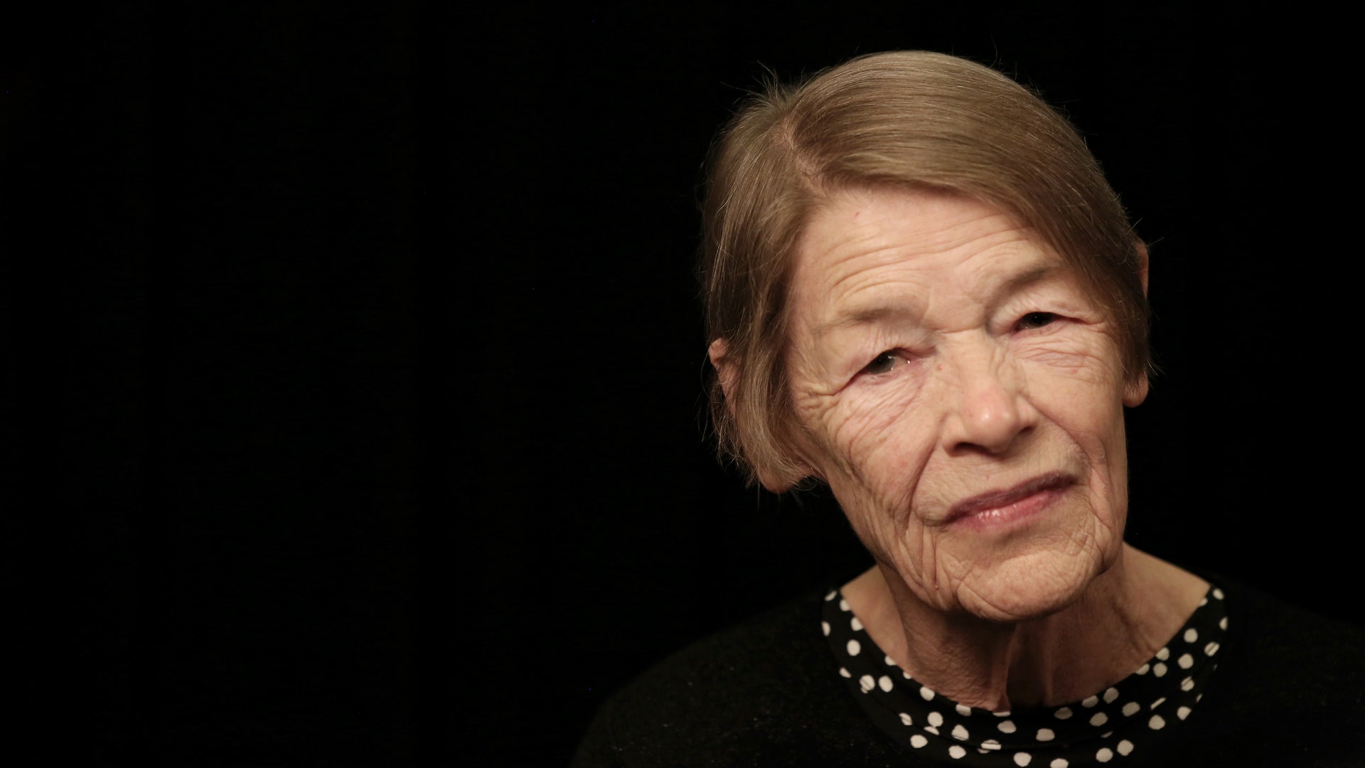 Glenda Jackson close up on black background