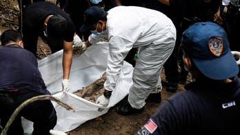 Malaysia charges 4 Thais over mass graves and human trafficking camps found in 2015