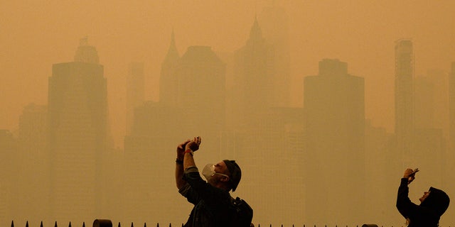 People take pictures of the haze